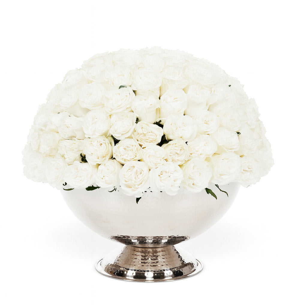 Bouquet of white flowers in a silver vase on a white background