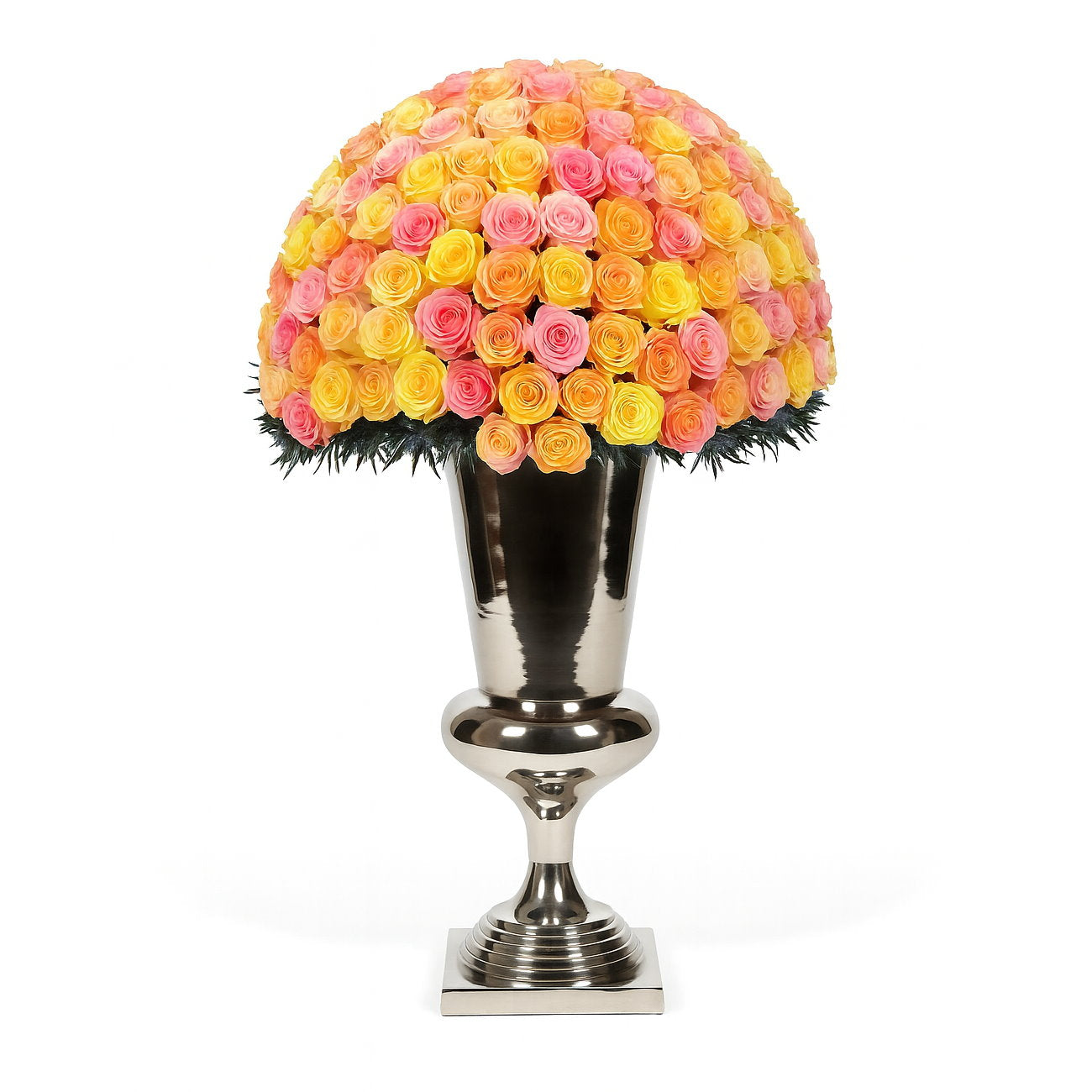 Decorative flower arrangement with pink and yellow roses in a silver urn on a white background
