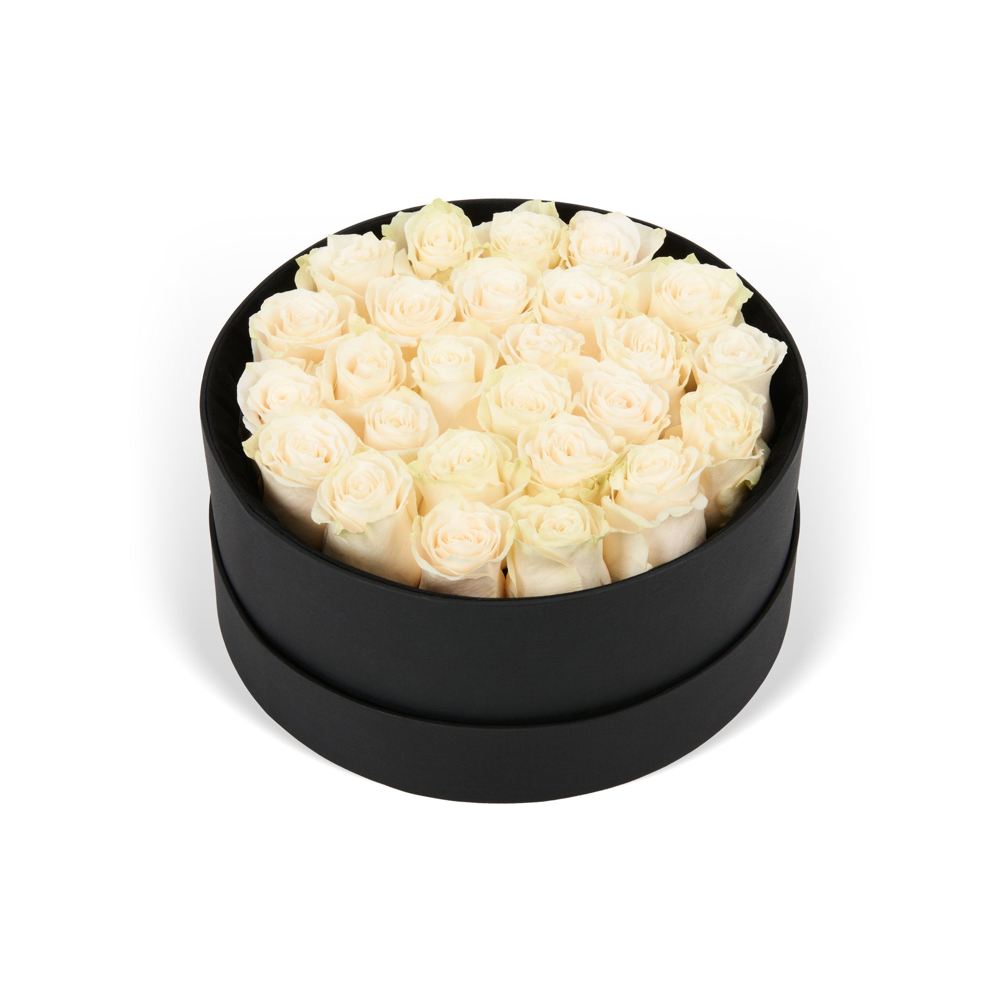 Black round box filled with white roses on a white background