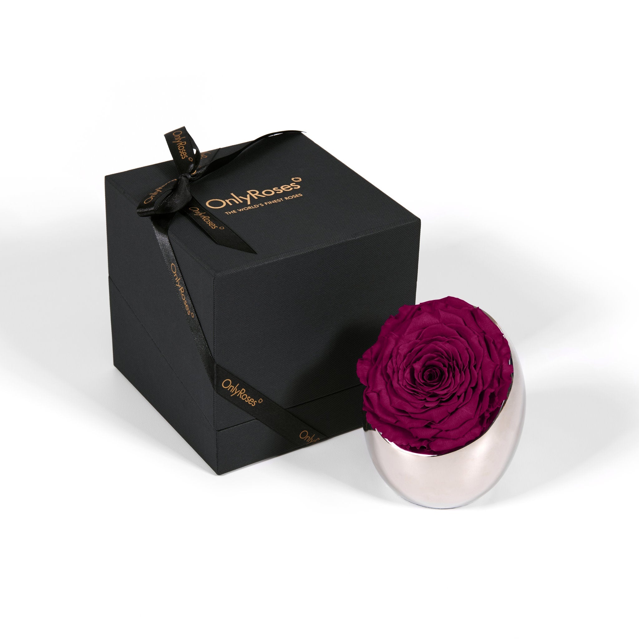 Black gift box with a gold bow and 'Only Roses' branding, containing a preserved purple rose in a silver holder.