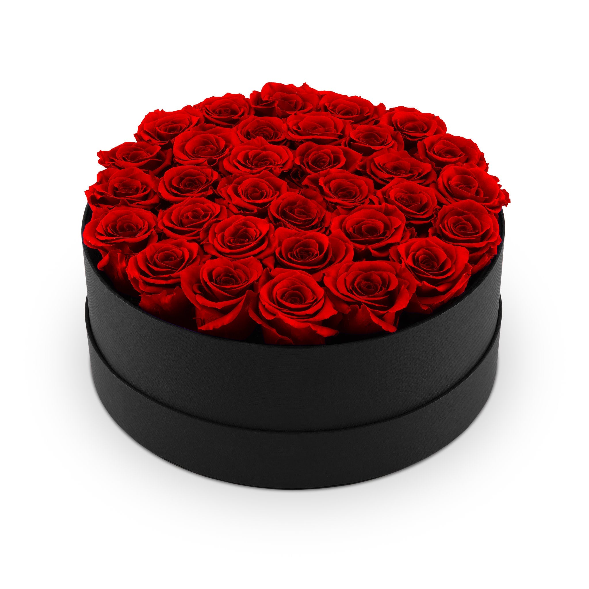 Black round box filled with red roses on a white background