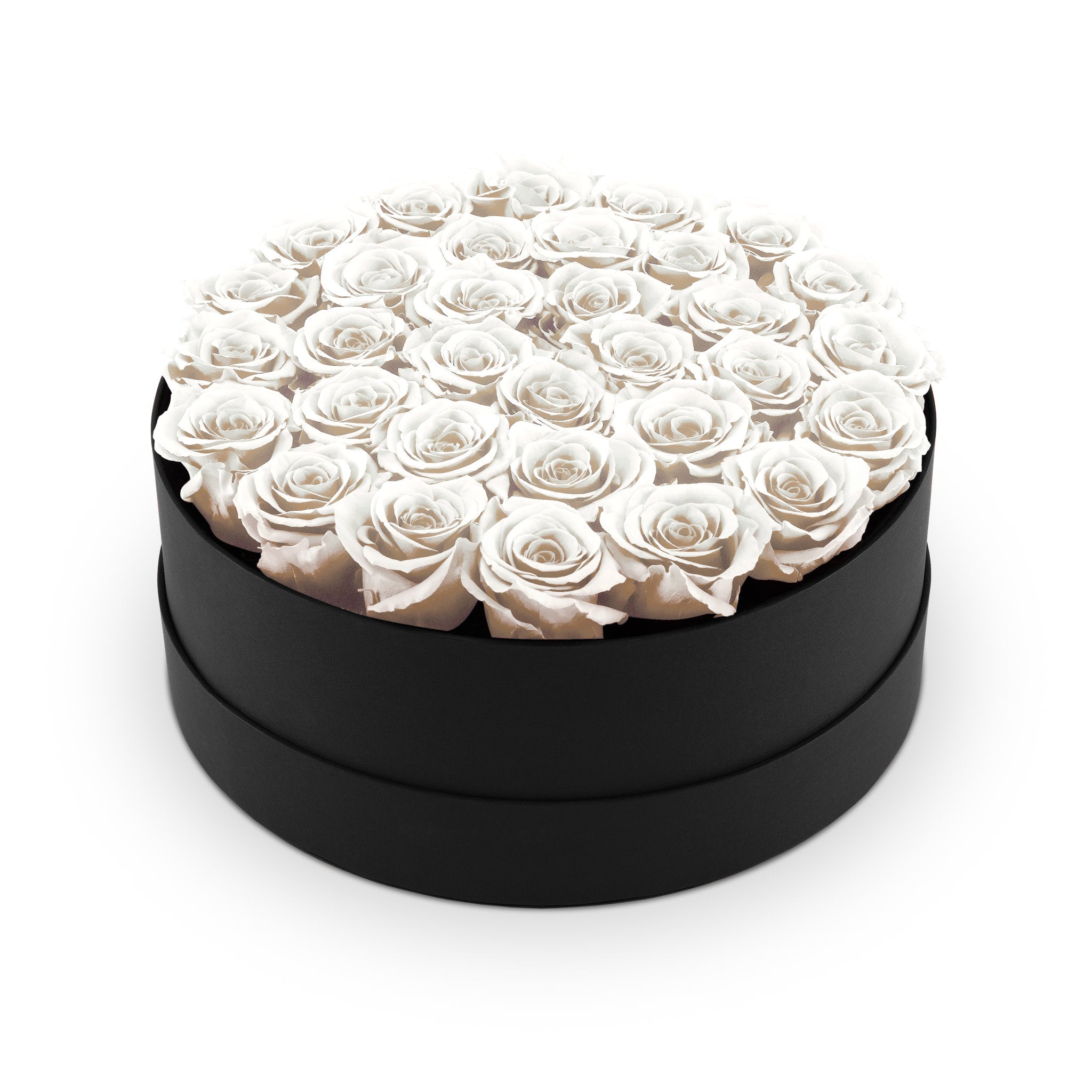 Black round box filled with white roses on a white background