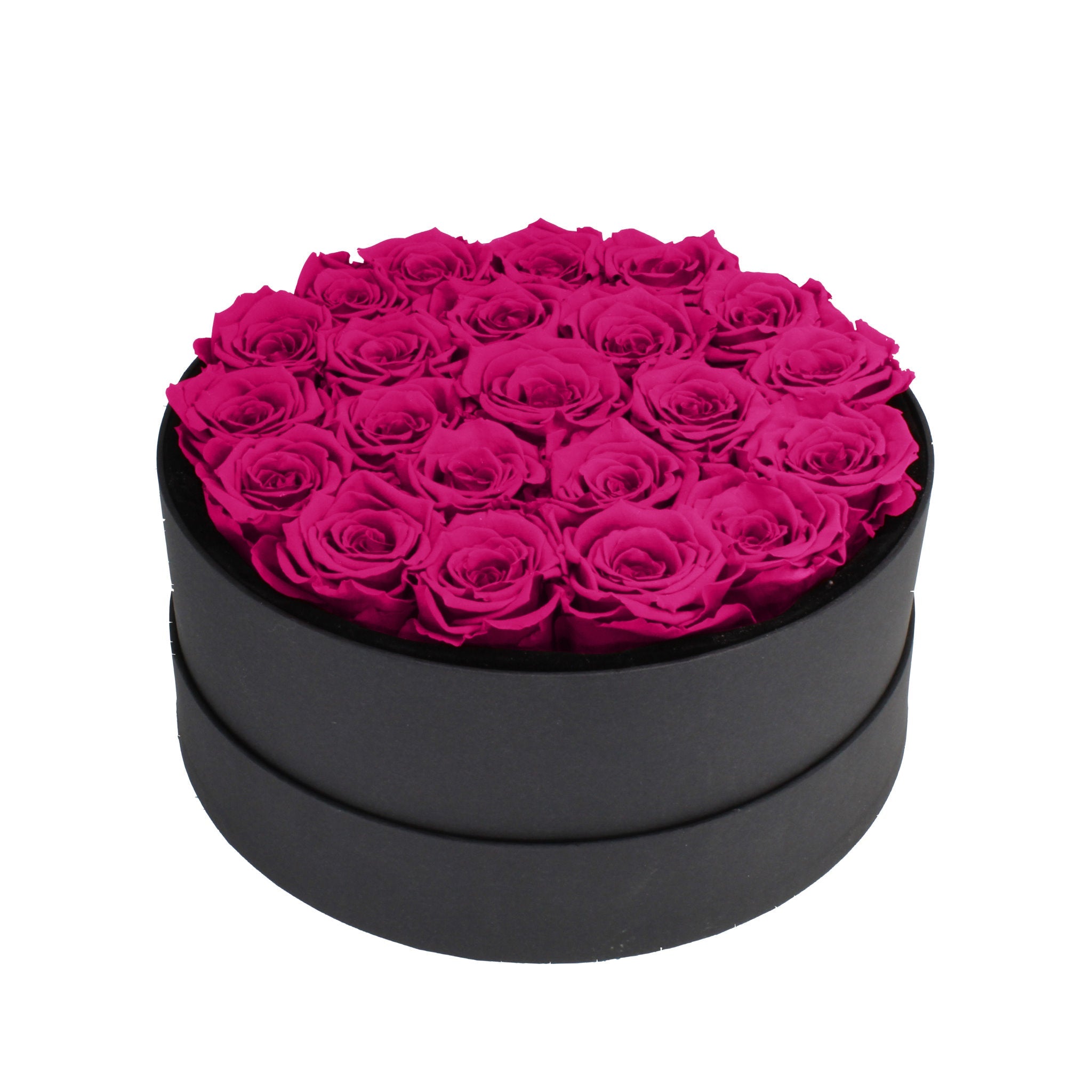 Black round box filled with pink roses on a white background