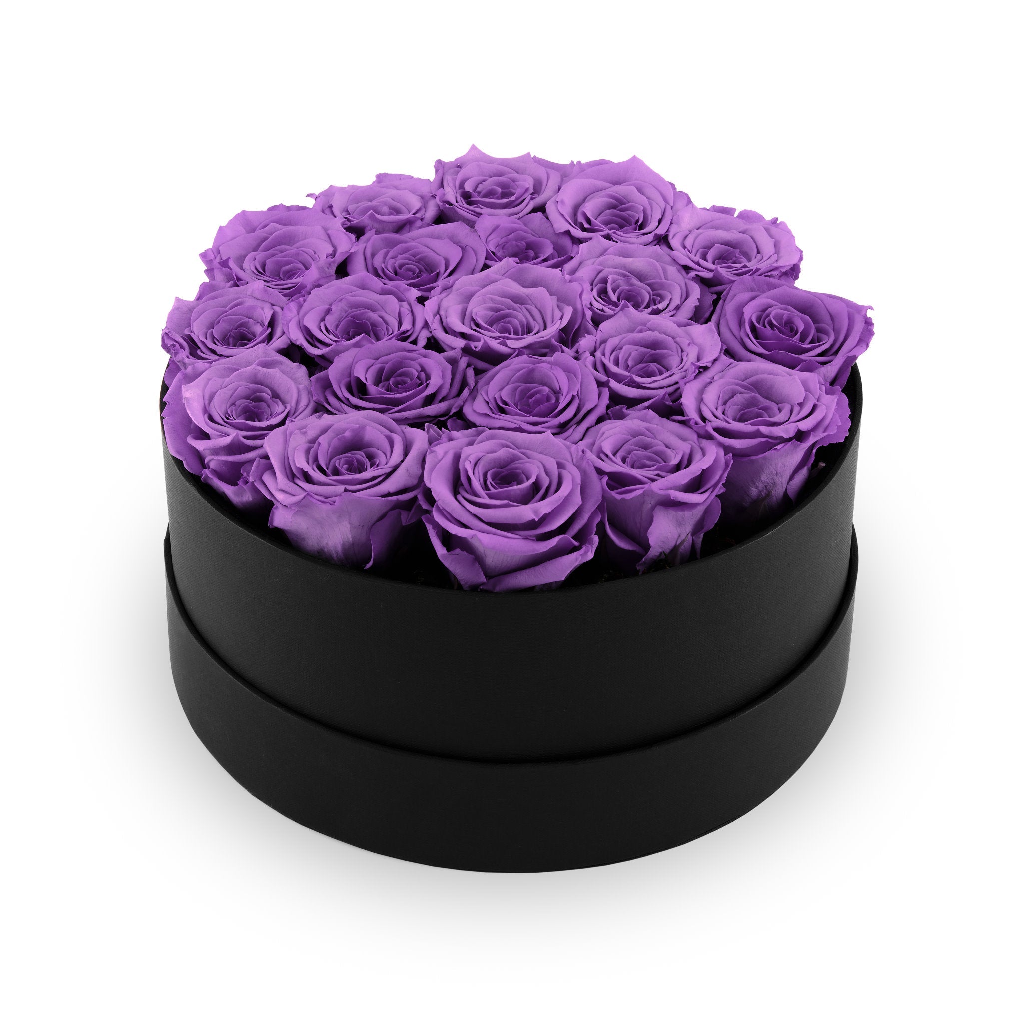 Black round box filled with purple roses on a white background
