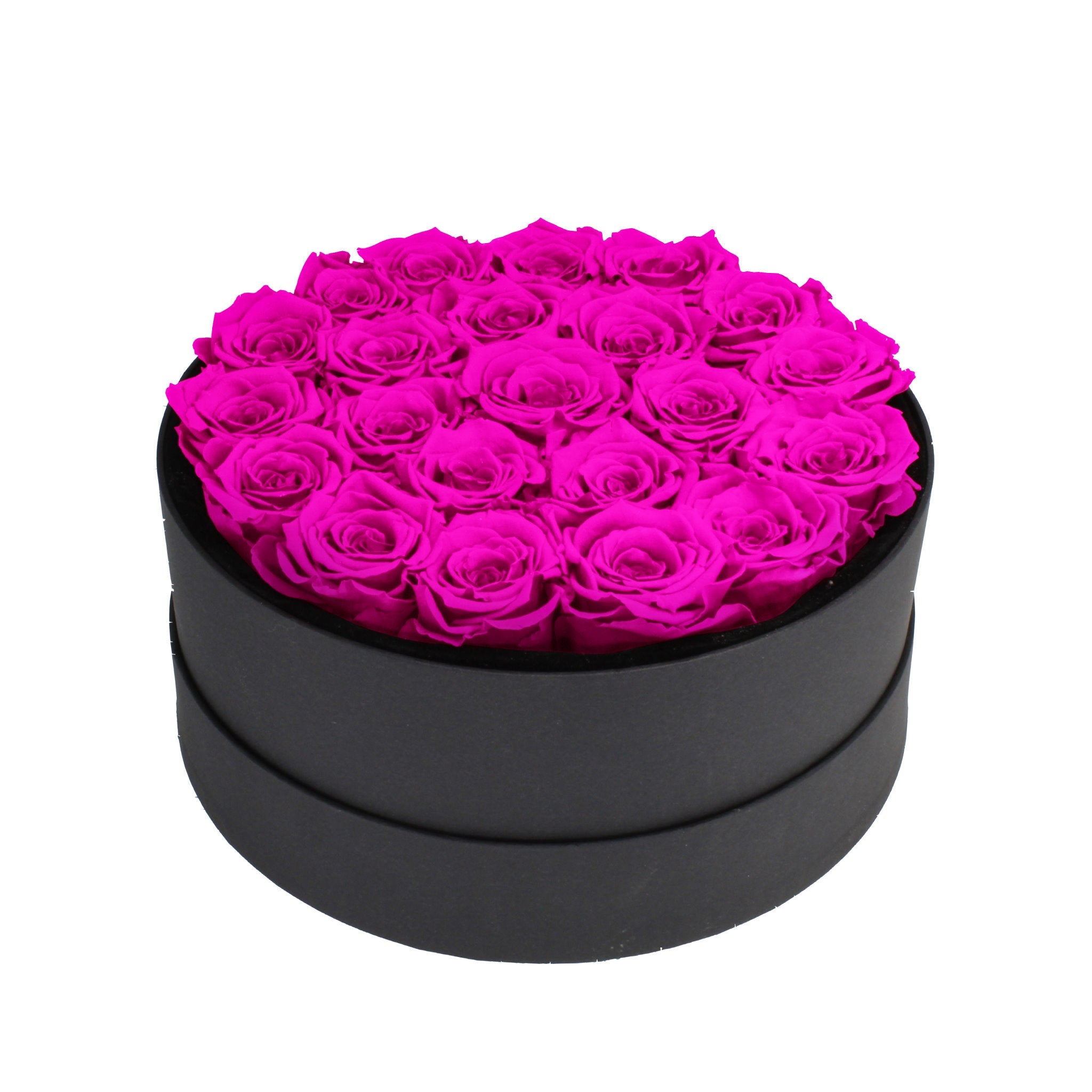 Black round box filled with bright pink roses on a white background