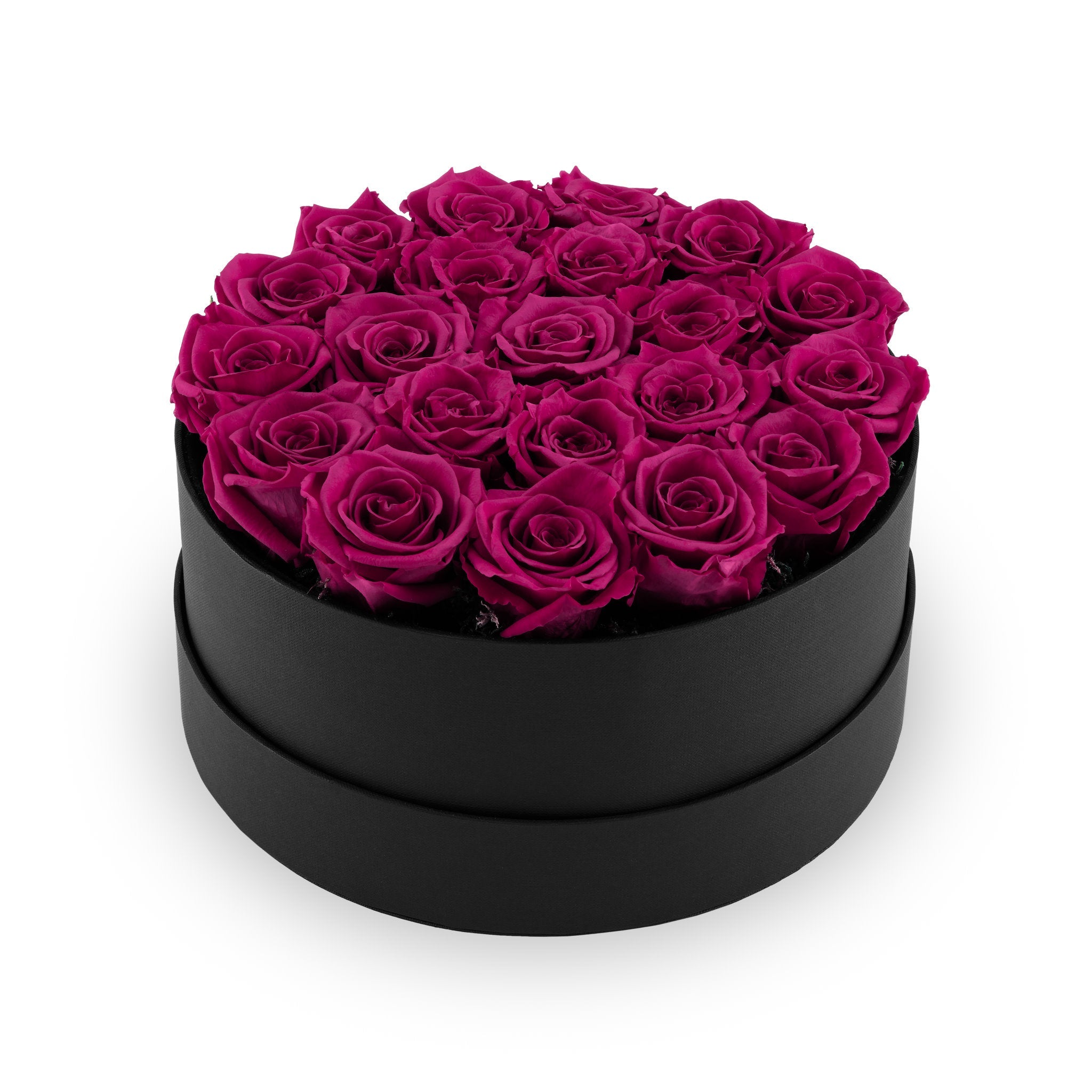 Black round box filled with pink roses on a white background