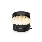 Black round box with white flowers on a white background