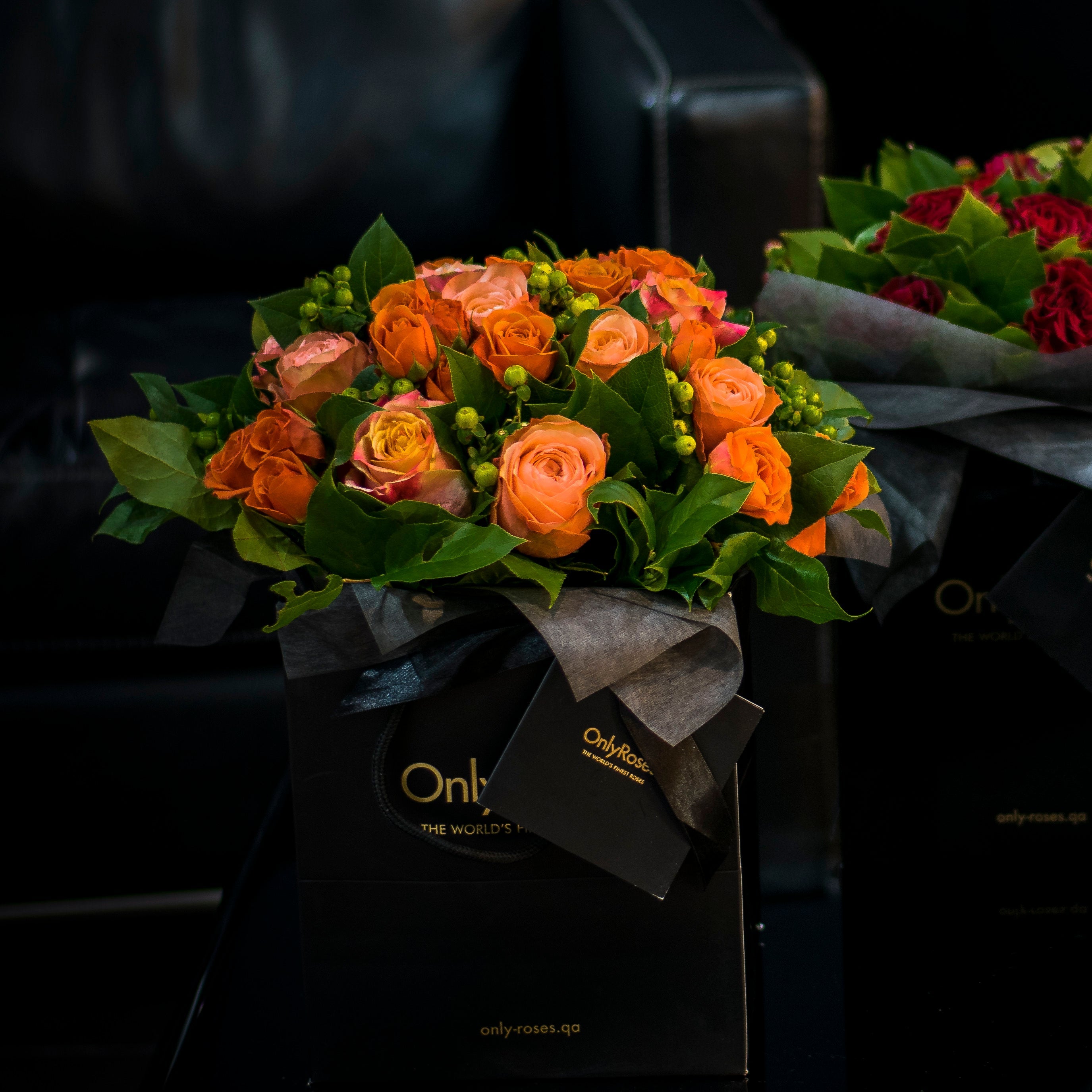 Bouquet of flowers with 'Only Roses' branding on a dark background