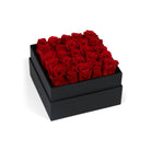 Black box filled with red roses on a white background