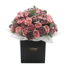 Bouquet of pink and purple flowers in a black box with 'Only Roses' branding on a white background.