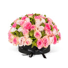 Bouquet of pink and white roses in a black box on a white background