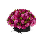 Bouquet of pink roses in a black box on a white background