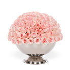 Bouquet of pink roses in a silver vase on a white background
