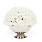 Bouquet of white flowers in a silver vase on a white background