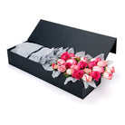Black box with pink and white roses on a white background