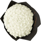 Bouquet of white roses in a black box with 'Only Roses' branding.