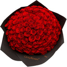 Bouquet of red roses wrapped in black paper with 'OnlyRoses' branding.