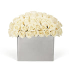 Bouquet of white roses in a silver box on a white background