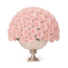 Bouquet of pink roses in a decorative vase on a white background