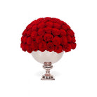 Bouquet of red roses in a decorative silver vase on a white background