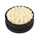 Black box filled with white roses on a white background
