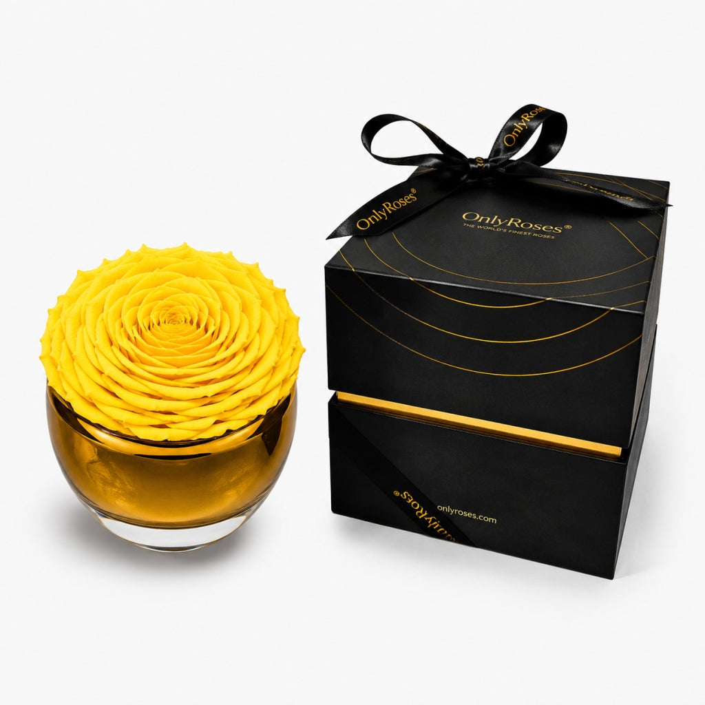 Yellow flower arrangement in a glass bowl with a black box labeled 'Only Roses' on a white background
