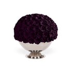 Decorative sphere made of purple roses on a white pedestal against a white background