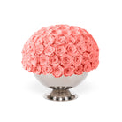 Bouquet of pink roses in a decorative container on a white background