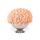 Bouquet of peach roses in a white vase on a white background