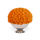 Spherical arrangement of orange roses on a white pedestal against a white background