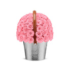 Pink rose basket with a brown handle on a white background