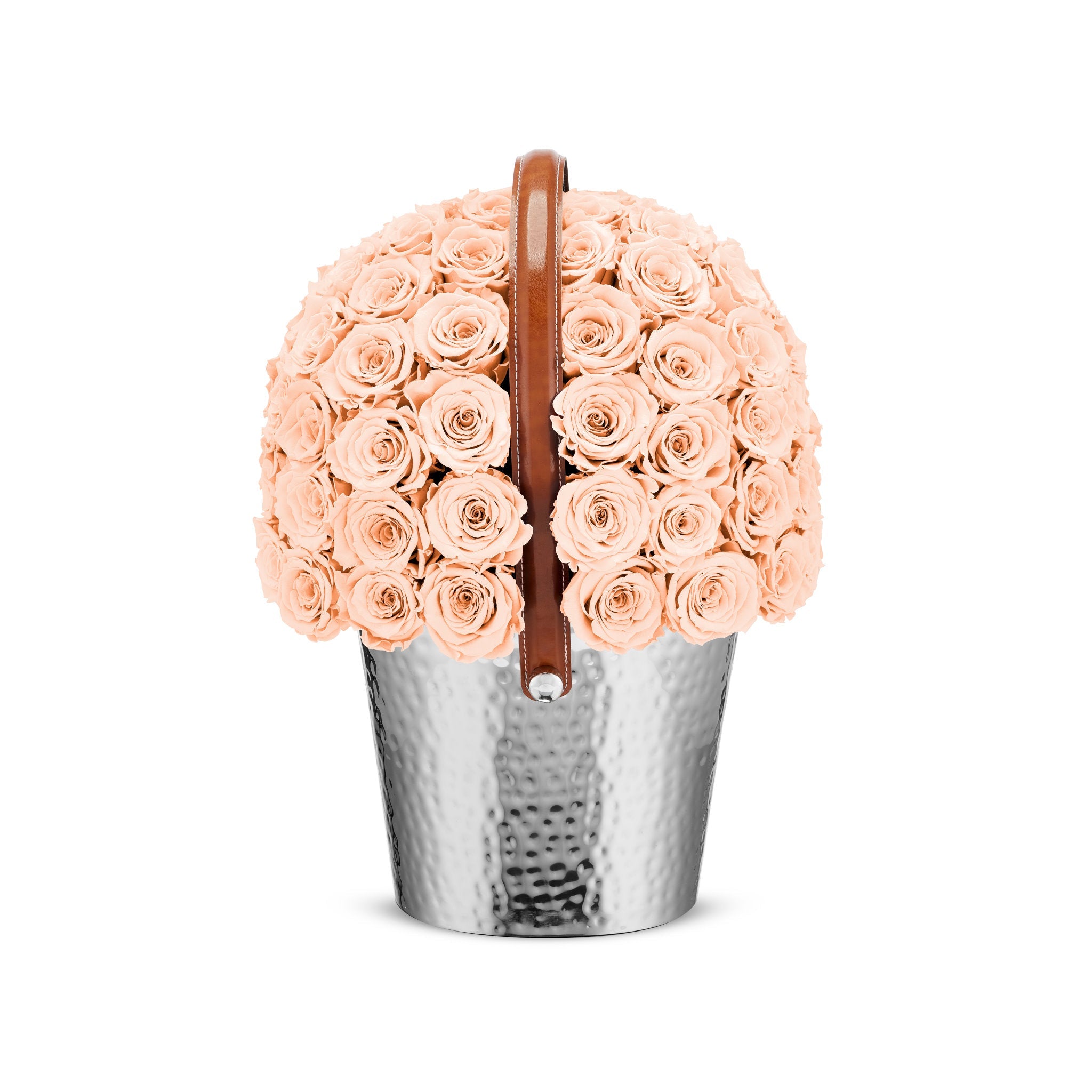 Bouquet of peach roses in a silver metal container with a brown handle on a white background