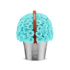 Bouquet of turquoise roses in a silver bucket with a brown handle on a white background