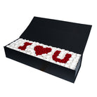 Black box with 'I ❤️ U' made of red and white flowers on a white background