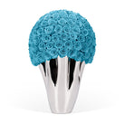 Silver vase with blue roses on a white background