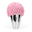 Silver vase with pink roses on a white background