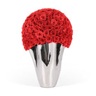 Silver vase with a large ball of red roses on a white background