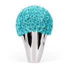 Silver vase with turquoise roses on a white background