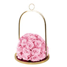 Pink roses in a gold holder on a white background