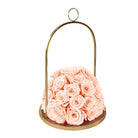 Pink roses in a gold metal holder on a white background