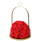 Red roses in a gold holder on a white background