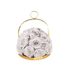 Gold hoop container with white roses on a white background
