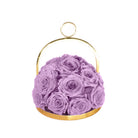 Purple roses in a gold metal holder on a white background