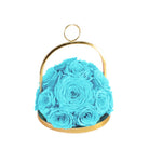 Blue roses in a gold holder on a white background