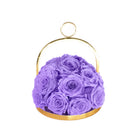 Purple roses in a gold metal basket on a white background