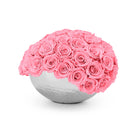 Pink rose sphere in a white vase on a white background