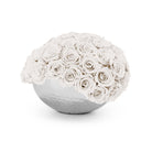 White spherical vase filled with white roses on a white background