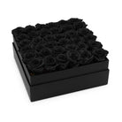 Black box filled with black roses on a white background