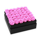 Black box filled with pink roses on a white background