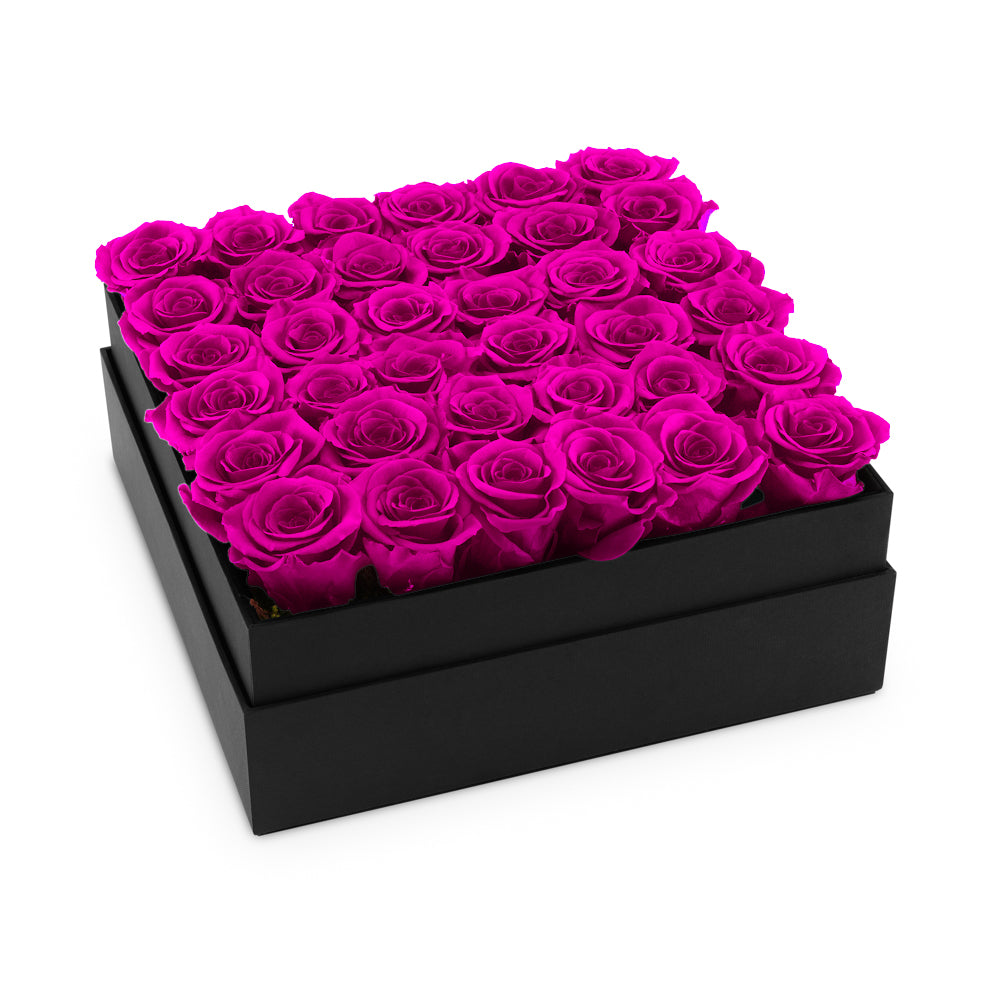 Black box filled with pink roses on a white background
